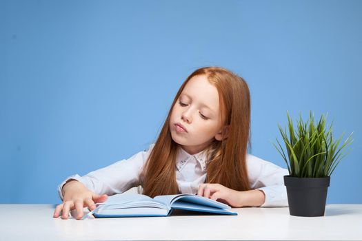 schoolgirl doing homework at the table education learning. High quality photo