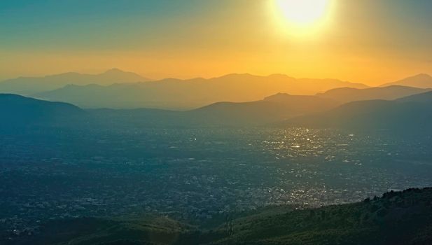 Panoramic view over Athens, taken shot from Penteli mountain at sunset.