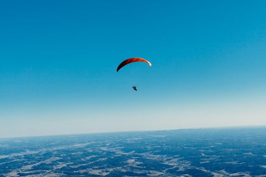sailing on a paraglider in the blue sky.