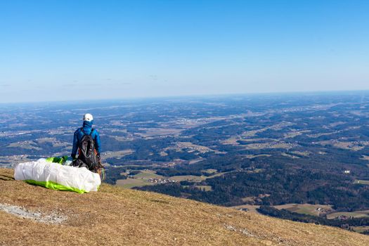 sports paragliding on a parachute over the countryside.