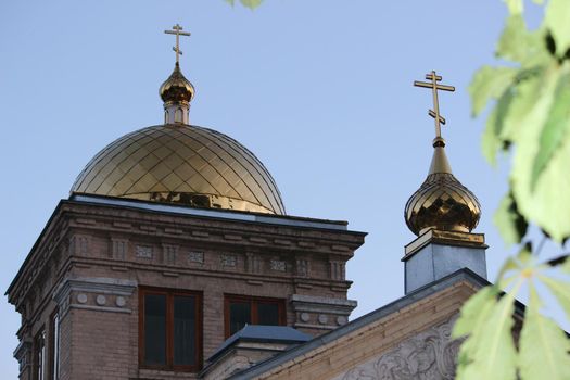 Orthodoxy. The golden domes of the Christian temple against the blue sky.