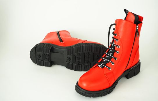 Fashionable womens shoes are red, with zipper and lacing, insulated on a white background. High quality photo