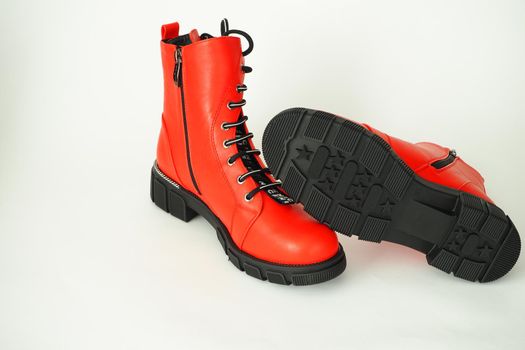 Fashionable womens shoes are red, with zipper and lacing, insulated on a white background. High quality photo