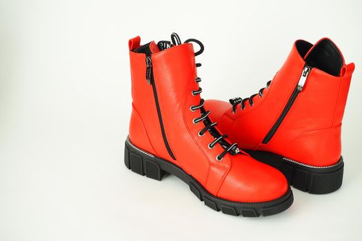 Fashionable womens shoes are red, with zipper and lacing, insulated on a white background. High quality photo