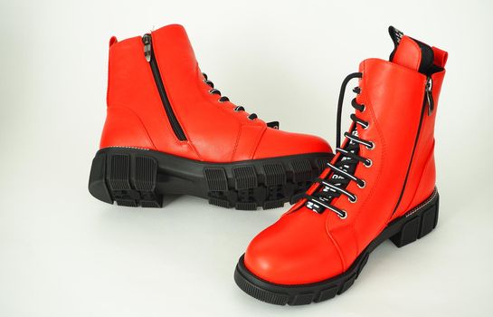 Fashionable womens shoes are red, with zipper and lacing, insulated on a white background. High quality photo