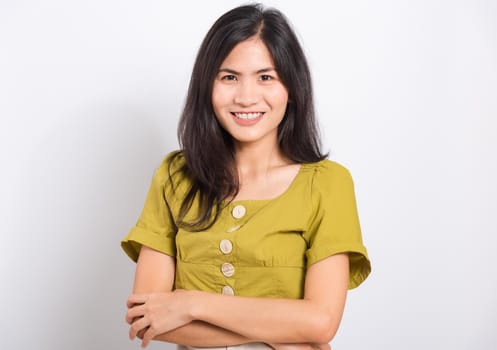 Portrait Asian beautiful young woman standing smile seeing white teeth, She crossed her arms and looking at camera, shoot photo in studio on white background