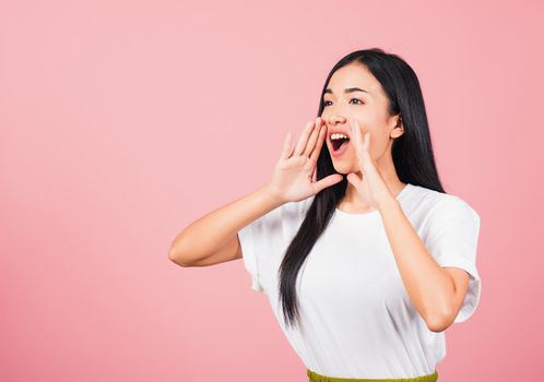 Asian happy portrait beautiful cute young woman teen standing hand on mouth talking news announcement studio shot isolated on pink background, Thai female looking to side away with copy space