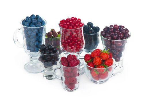 different summer berries red currant, gooseberry, raspberry in glass trays. sorted by type.