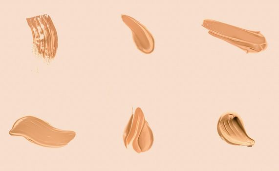 Liquid foundation smudges, smears and strokes as makeup textures isolated on beige background, beauty and cosmetics set