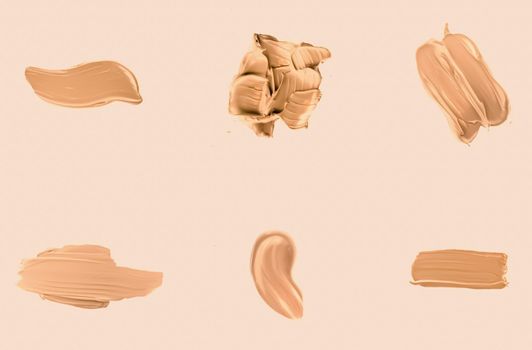 Liquid foundation smudges, smears and strokes as makeup textures isolated on beige background, beauty and cosmetics set