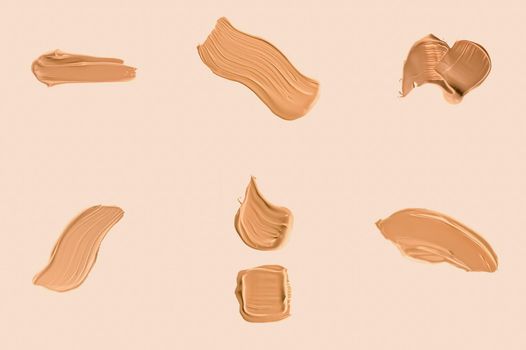 Liquid foundation smudges, smears and strokes as makeup textures isolated on beige background, beauty and cosmetics set