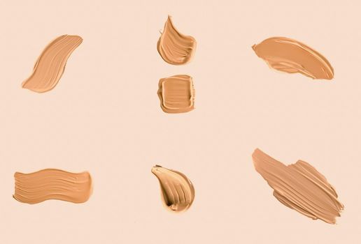 Liquid foundation smudges, smears and strokes as makeup textures isolated on beige background, beauty and cosmetics set