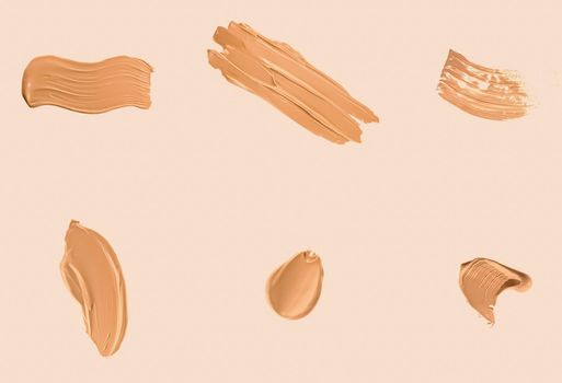 Liquid foundation smudges, smears and strokes as makeup textures isolated on beige background, beauty and cosmetics set