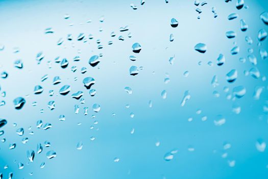 Liquid water drops on glass surface, abstract backdrop and science background concept