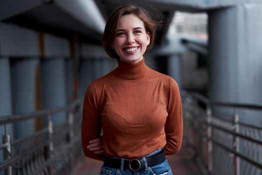 Woman portrait Happy smiling confidence brunette dressed brown turtleneck dark background dramatic atmosphere Caucasian female headshoot Women's golf sweater style