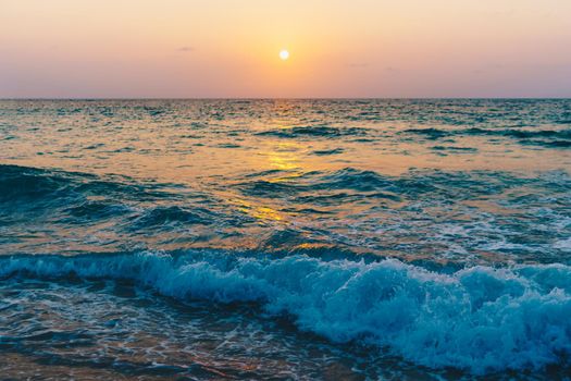 Colorful vibrant ocean sea wave beach summer with sunrise or sunset background landscape on vacation day. 