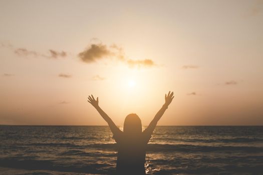 Woman rise hands up to sky travel around the world with summer beach freedom and relax life.