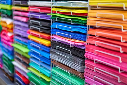 Sheets colored cardboard for designer creative works. Stacks multicolored drawing paper in the store. Colorful art papers on shelf for sale stationery store