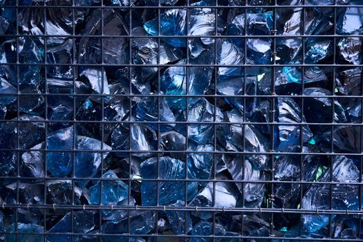 Blue Crystal Mineral Stone. Gems. Artificial crystals in stone cage modern construction wall background Texture of precious and semiprecious stones. colored shiny surface of precious stones.