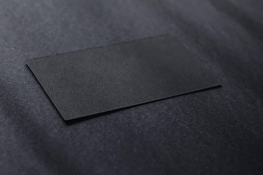 Black business card on dark flatlay background and sunlight shadows, luxury branding flat lay and brand identity design for mockups