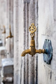 Water tap for washing hands and feet before the prayer in ablution faucets in the Suleymaniye Mosque, Istanbul, Turkey.