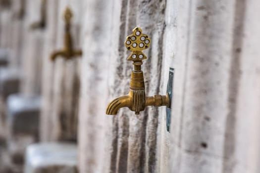 Water tap for washing hands and feet before the prayer in ablution faucets in the Suleymaniye Mosque, Istanbul, Turkey.