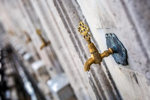 Water tap for washing hands and feet before the prayer in ablution faucets in the Suleymaniye Mosque, Istanbul, Turkey.