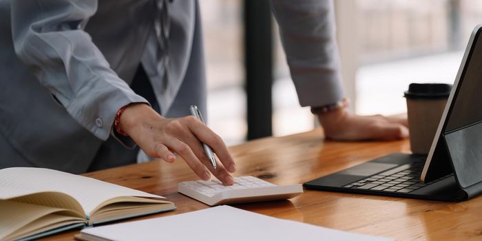 Close up of businesswoman accountant or banker making calculations.Business Financing Accounting Banking Concept