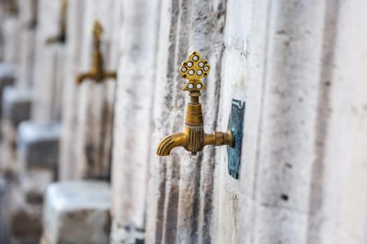 Water tap for washing hands and feet before the prayer in ablution faucets in the Suleymaniye Mosque, Istanbul, Turkey.