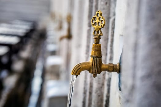 Water tap for washing hands and feet before the prayer in ablution faucets in the Suleymaniye Mosque, Istanbul, Turkey.