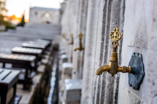 Water tap for washing hands and feet before the prayer in ablution faucets in the Suleymaniye Mosque, Istanbul, Turkey.