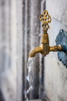Water tap for washing hands and feet before the prayer in ablution faucets in the Suleymaniye Mosque, Istanbul, Turkey.