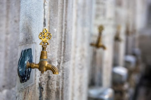 Water tap for washing hands and feet before the prayer in ablution faucets in the Suleymaniye Mosque, Istanbul, Turkey.