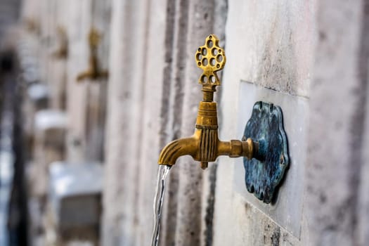 Water tap for washing hands and feet before the prayer in ablution faucets in the Suleymaniye Mosque, Istanbul, Turkey.