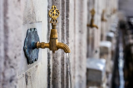Water tap for washing hands and feet before the prayer in ablution faucets in the Suleymaniye Mosque, Istanbul, Turkey.