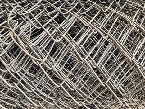 close up rolls of iron mesh (wire mesh) in construction site. metal steel reinforced rod for concrete. building construction and industry concept - image