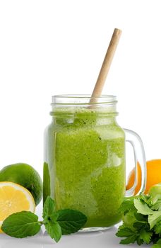Healthy green smoothie with spinach, mango, orange,lime, apple,citrone in glass jars.