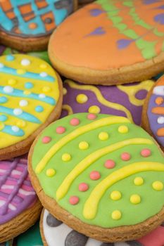 Easter decorated baked eggs, cookies as background.