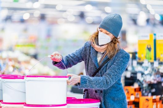 buying paint colors by young woman in the store.