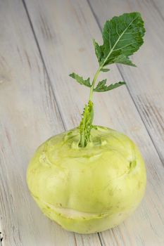 Fresh healthy kohlrabi sliced on wooden background.