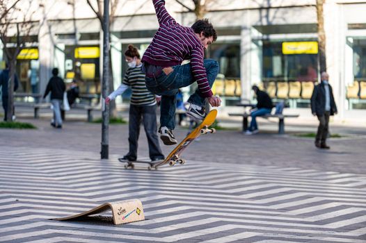 terni,italy march 16 2021:boys doing skateboard stunts in the city