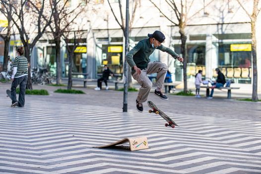 terni,italy march 16 2021:boys doing skateboard stunts in the city