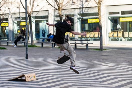 terni,italy march 16 2021:boys doing skateboard stunts in the city