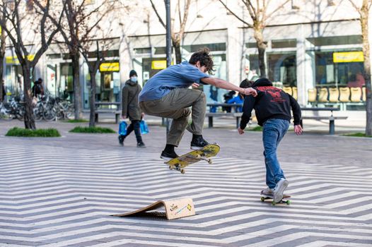 terni,italy march 16 2021:boys doing skateboard stunts in the city