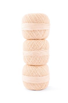 Close up shot of three spools of embroidery thread on top of each other, isolated on white background.