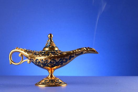 A magical lamp with a smoke trail over a blue gradient background.