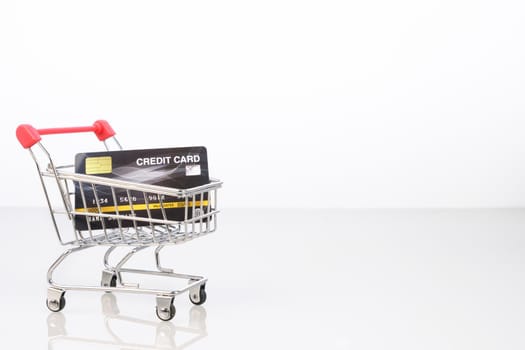 Credit card in shopping cart for online shopping on white, Work from home concept