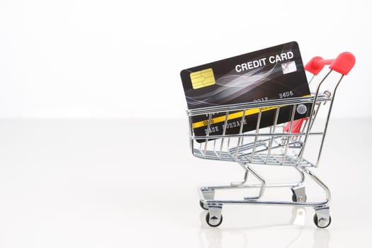 Credit card in shopping cart for online shopping on white, Work from home concept