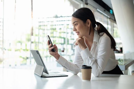 young woman shopping online with credit card using smart phone at cafe.