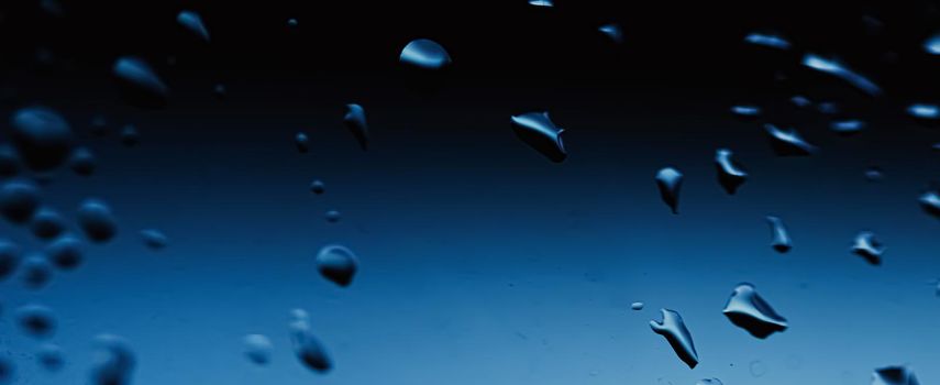 Liquid water drops on glass surface, abstract backdrop and science background concept